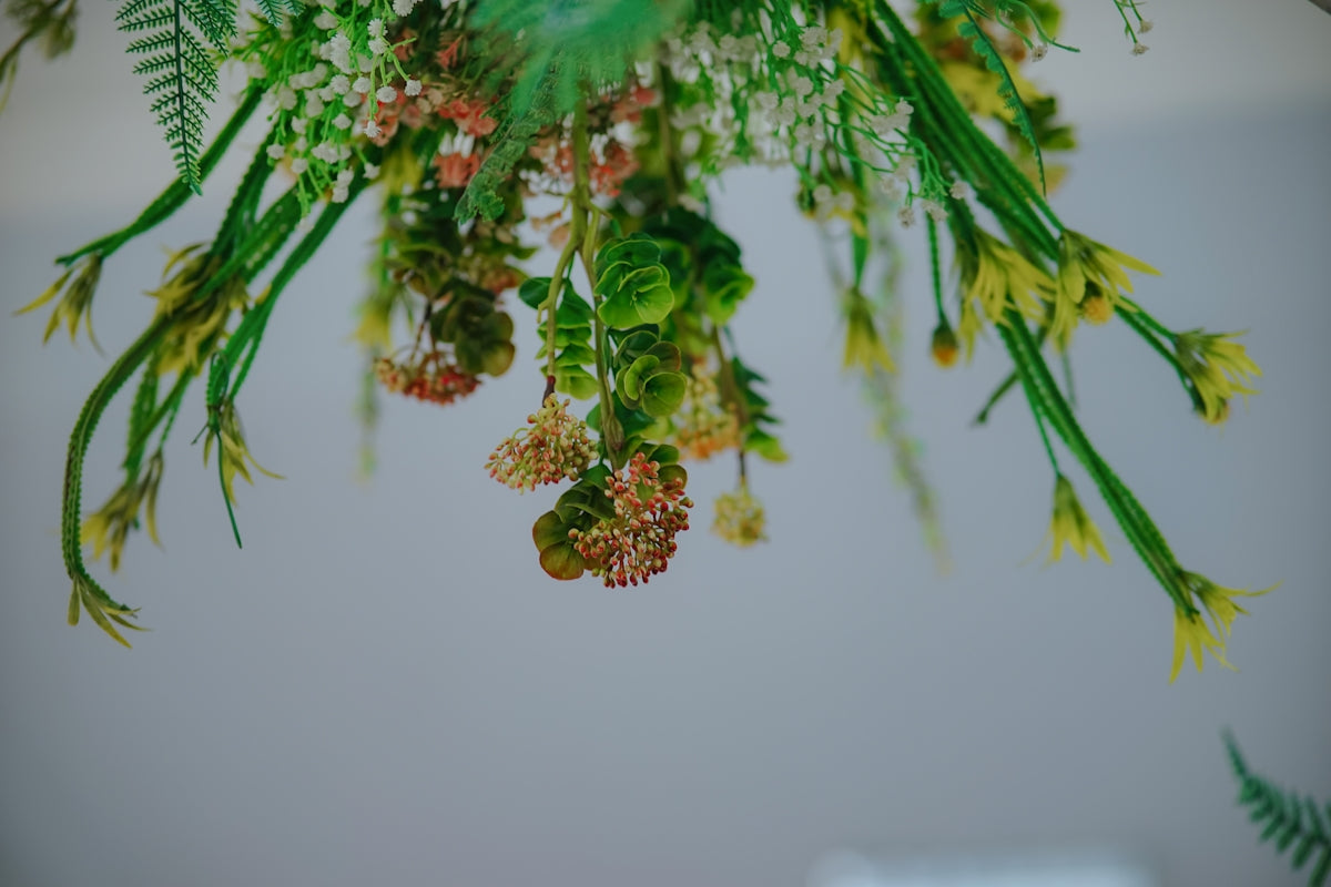 a bunch of flowers hanging from a ceiling
