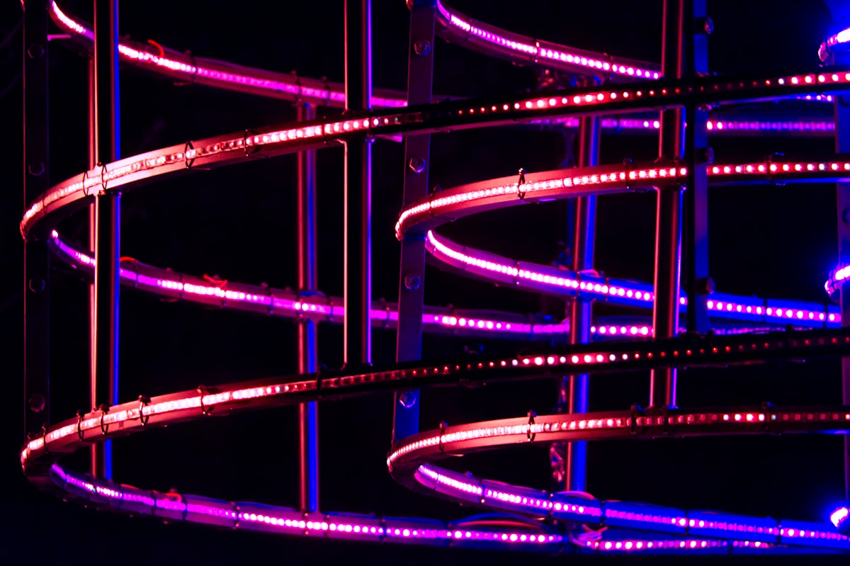 a close up of a neon lit object in the dark