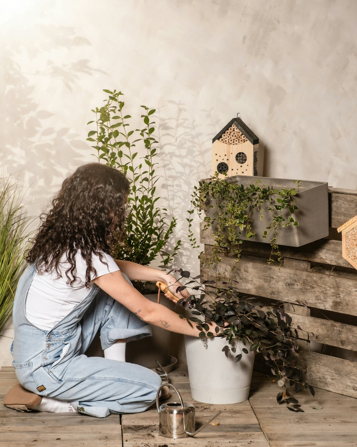 Woman tending to her plants in a beautiful garden.