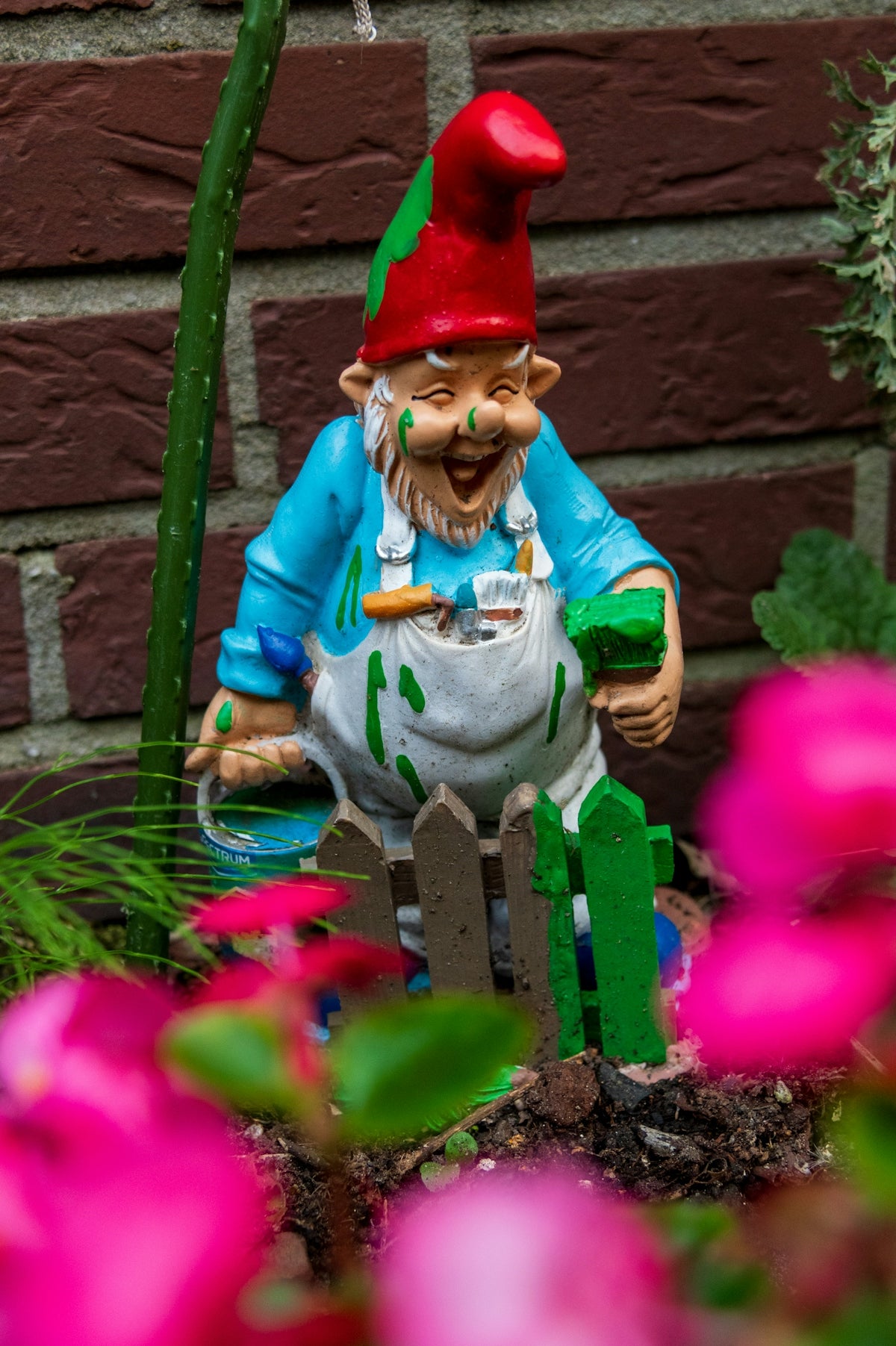 Garden gnome covered in green and blue paint